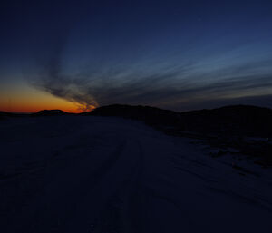 Last sunset with high cirrus clouds in a rocky terrain of Casey