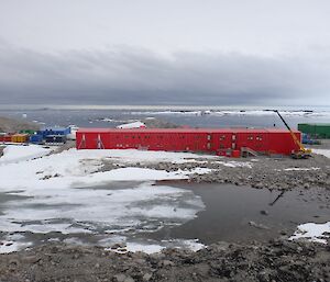 View of behind the Red Shed with the melt lake in the foreground