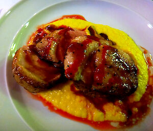 Duck breast dish with yellow coloured sauce.
