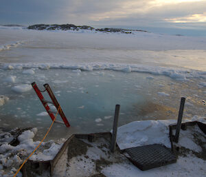 Icy water with a ladder sticking out