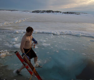 Aaron stepping into the freezing water