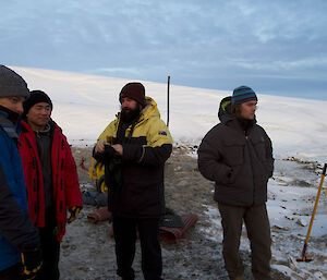 Onlookers wearing puffy warm clothes watching the swim