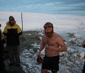 Matty just out of the water looking at his go pro camera