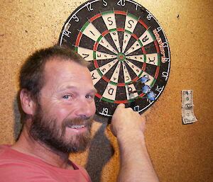 Mick showing off this dart on the board