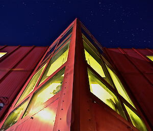 Low angle shot of the Red Shed’s large windows at night time