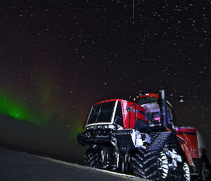 Aurora behind a large red Challenger truck