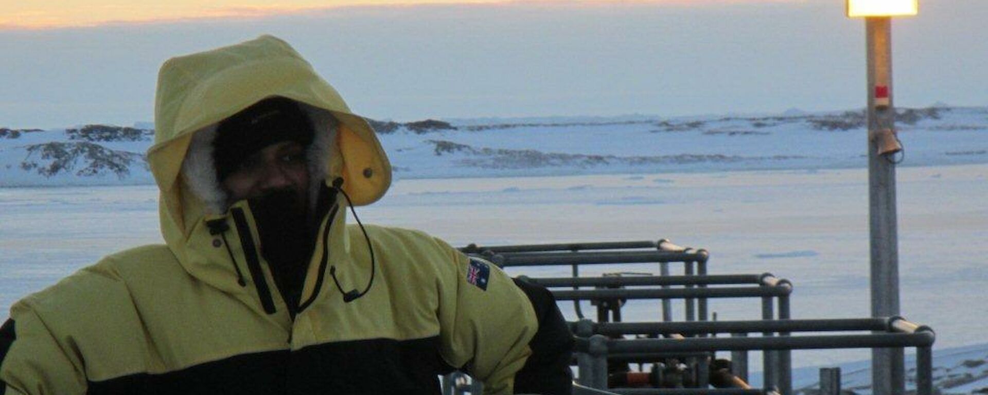 Abrar posing in the upper fuel farm over looking the frozen sea ice in the background