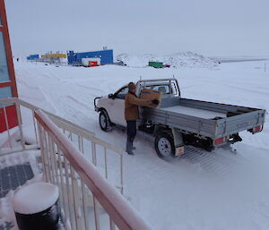 Aaron unloading the box of goods to the red shed