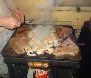 Cooking steak and prawns in the BBQ