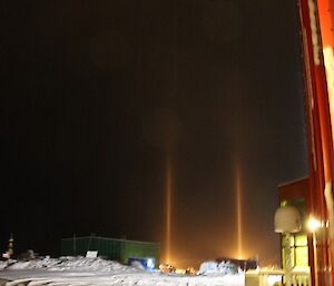 Casey station early morning with light beams due to light snowfall