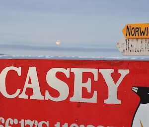 Red Casey sign with a colourful sun set