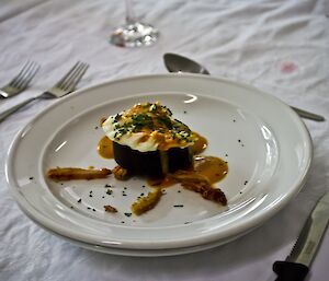 Black pudding and poached egg. Tomato hazelnut dressing, pork scratching