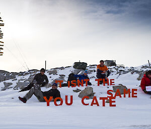 Group picture outside in front of the Casey sign with a short message for Cate