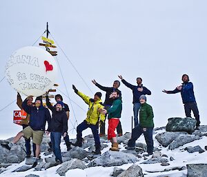 Group picture in front of the Casey sign for a marriage proposal