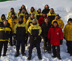 Winter group picture outside in front of a blizzard drift