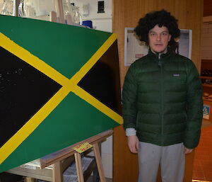 Dr Chad with a curly wig and the Jamaican flag