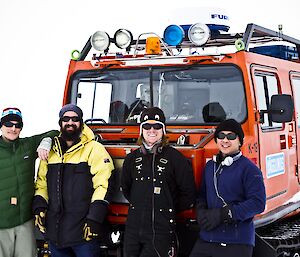 Chad, Leon, Ben and Michael standing in front of an orange Hagg