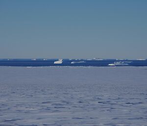 Icebergs in the background with snow terrain foreground