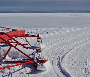 A large groomer, grooming the snow