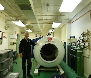 Gerry standing next to a Hyperbaric Chamber