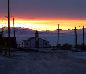 Sunset background with a small chapel in the foreground