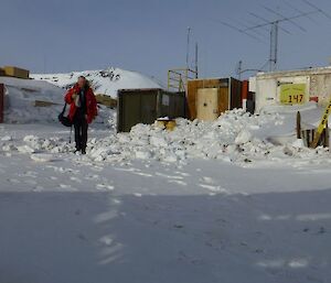 Gerry walking on snow covered street with buildings on both side