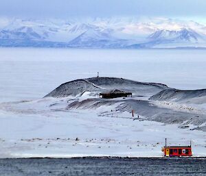 Scott’s hut in a bay with frozen sea ice