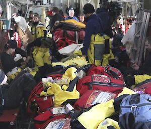 Shot inside the Hercules with bags and cargo with the passengers in a tight squeeze