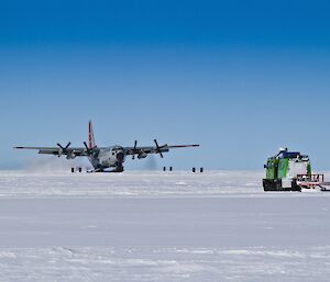 Hercules touching down with a green Hagg and a white bus in the foreground