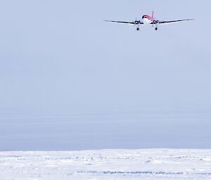 Red Basler on final approach on a snowy runway