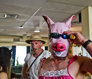 Mick wearing a pig mask with sunglasses