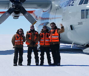 Hercules in the background with the four Aircraft Ground Support Officers