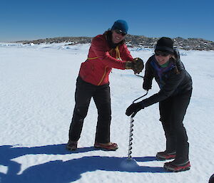 Tracey and Billy measuring the sea ice thickness in Shirley Island channel