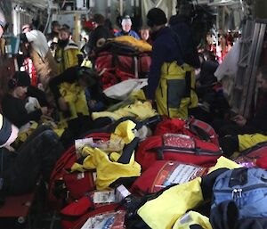 The interior of a different plane is a jumbled mass of backpacks