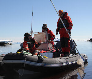 A group of expeditioners dipping the water for Antarctic creatures