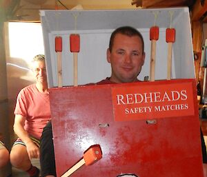 A man dressed as a box of Redheads matches