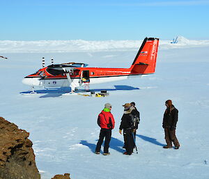 Expeditioners loading a Twin Otter aircraft on ice