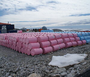 Arranging fuels by age- pink drums stacked beside blue drums