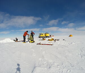 The whole team in action, Andrew, Krista and Tim taking core samples and Nick digging out the snow pit