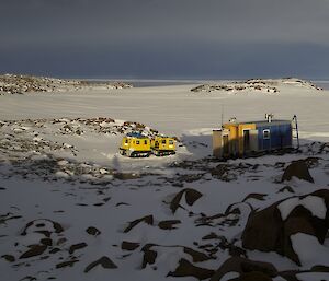 View over Browning hut with Hägglunds parked nearby.