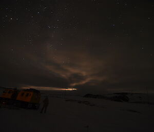 Moonlight over a hagglunds near Wilkes field hut, Antarctica