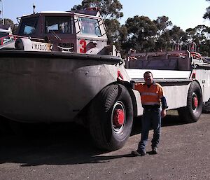 Expeditioner stands next to a LARC in Kingston, Tasmania