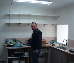 An expeditioner works on renovating the home brew room at Casey station, Antarctica