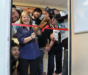 Station leader Ali cutting the ribbon at the brew room opening