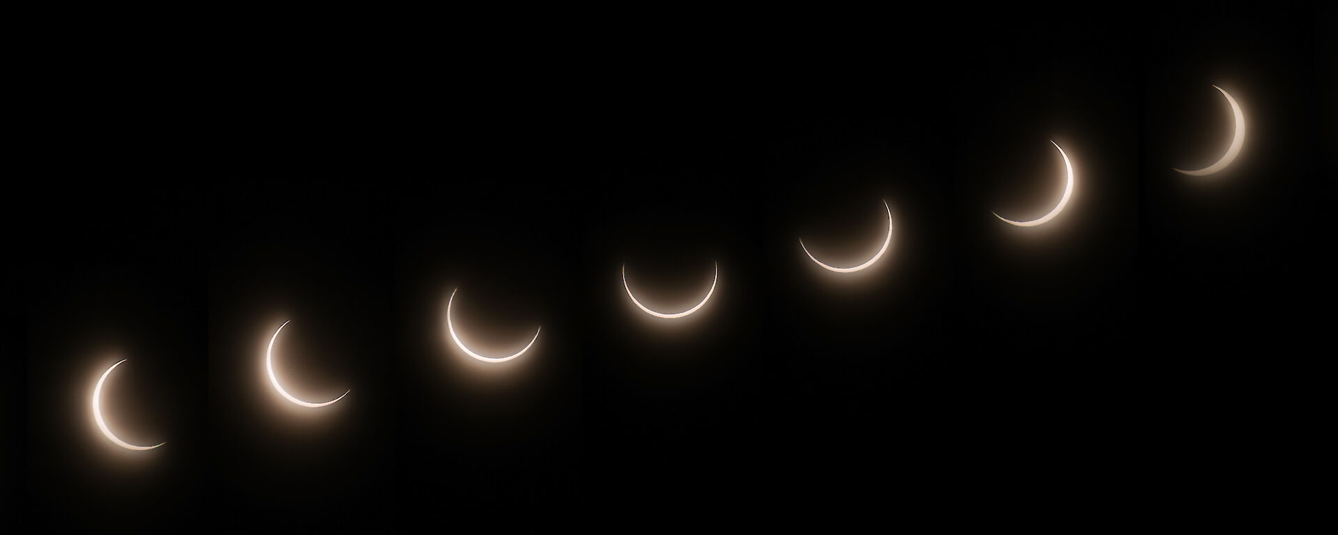 A sequence of images that show the progressive movement of the moon in front of the sun during a solar eclipse witnessed at Casey as a partial solar eclipse.