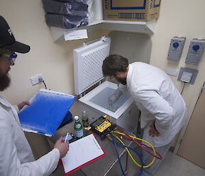 Steve Hankins placing bottles of water in the freezer