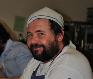 A close up of chef Eddie in traditional chef attire
