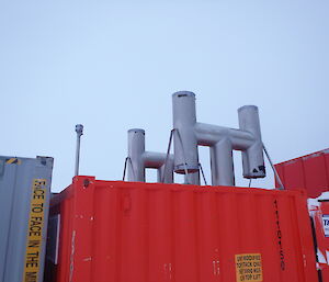 H cowls for ventilation even in a blizzard in place and secure on top of the generator container