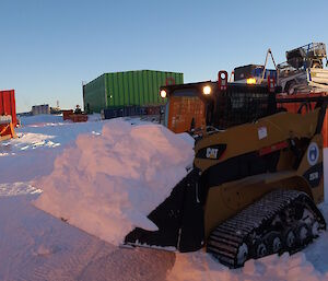 Cary Collis in the bobcat moving snow at Casey