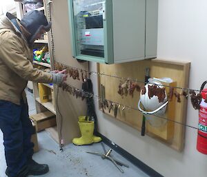 An expeditioner hanging up some beef jerky for drying.